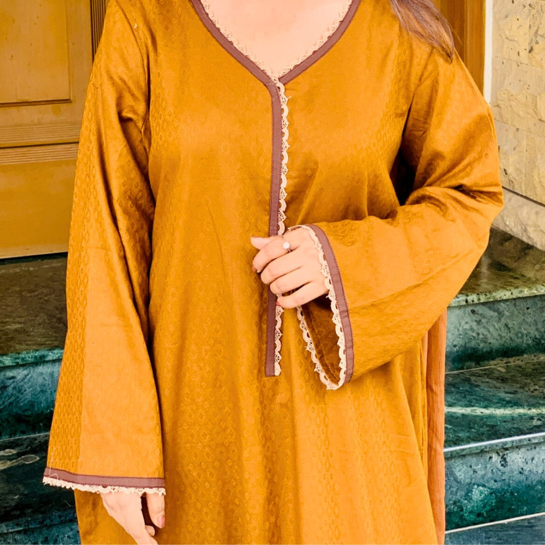 Person wearing a mustard yellow long-sleeve top